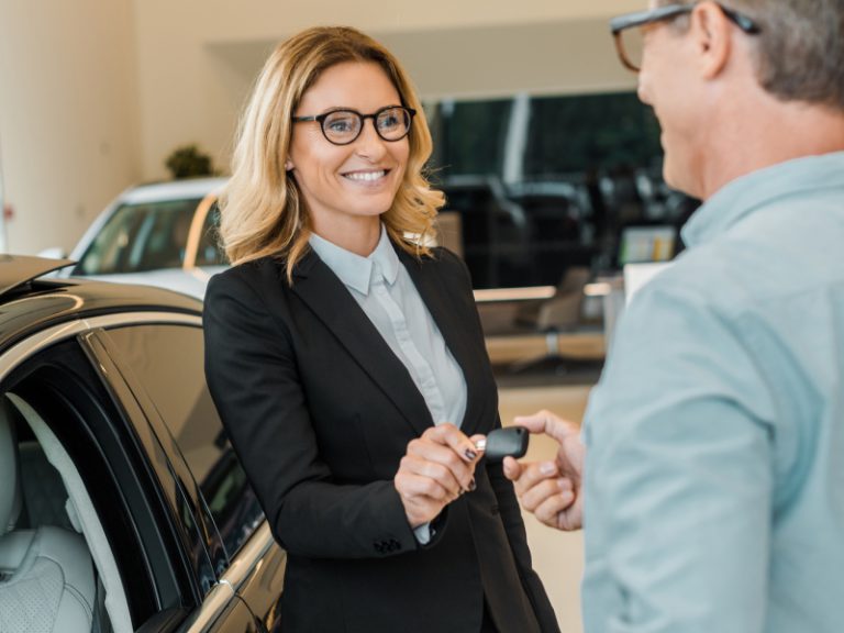 Photo of car rental agent handing over care hire keys